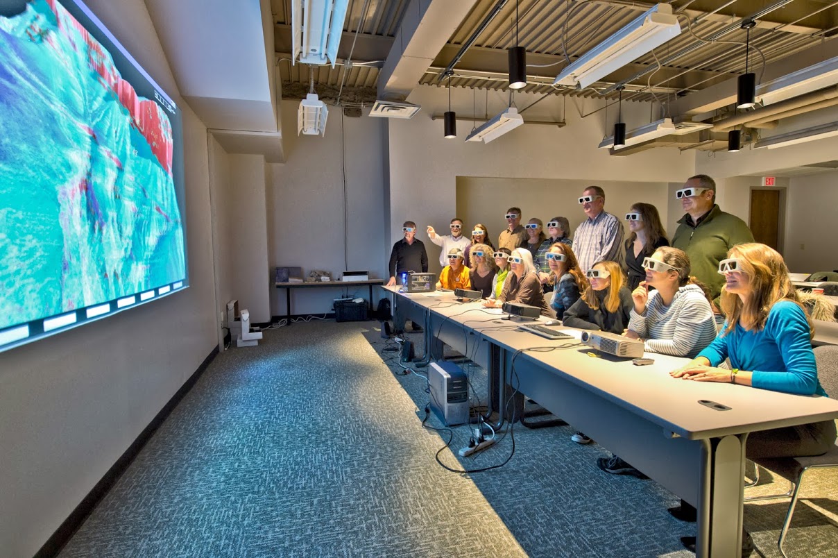 3D stereoscopic active projector system and viewing audience wearing shutter glasses.